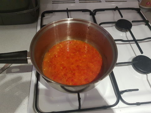 Chillis being cooked in the saucepan